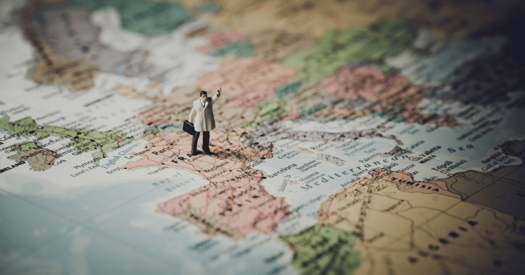 A clay man standing on a map. Things You Need To Plan A Trip