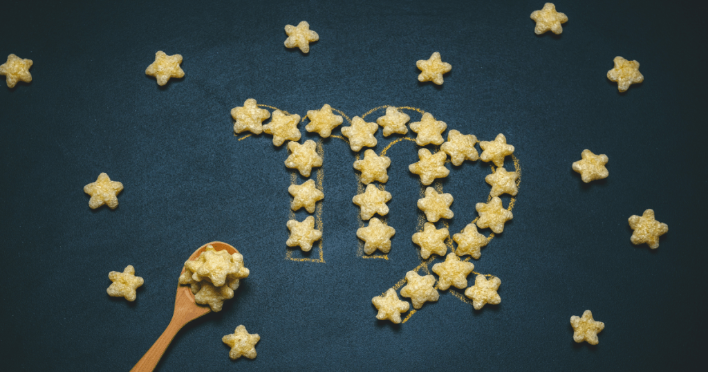 A blue background with star shaped cereal making the zodiac sign of Virgo.